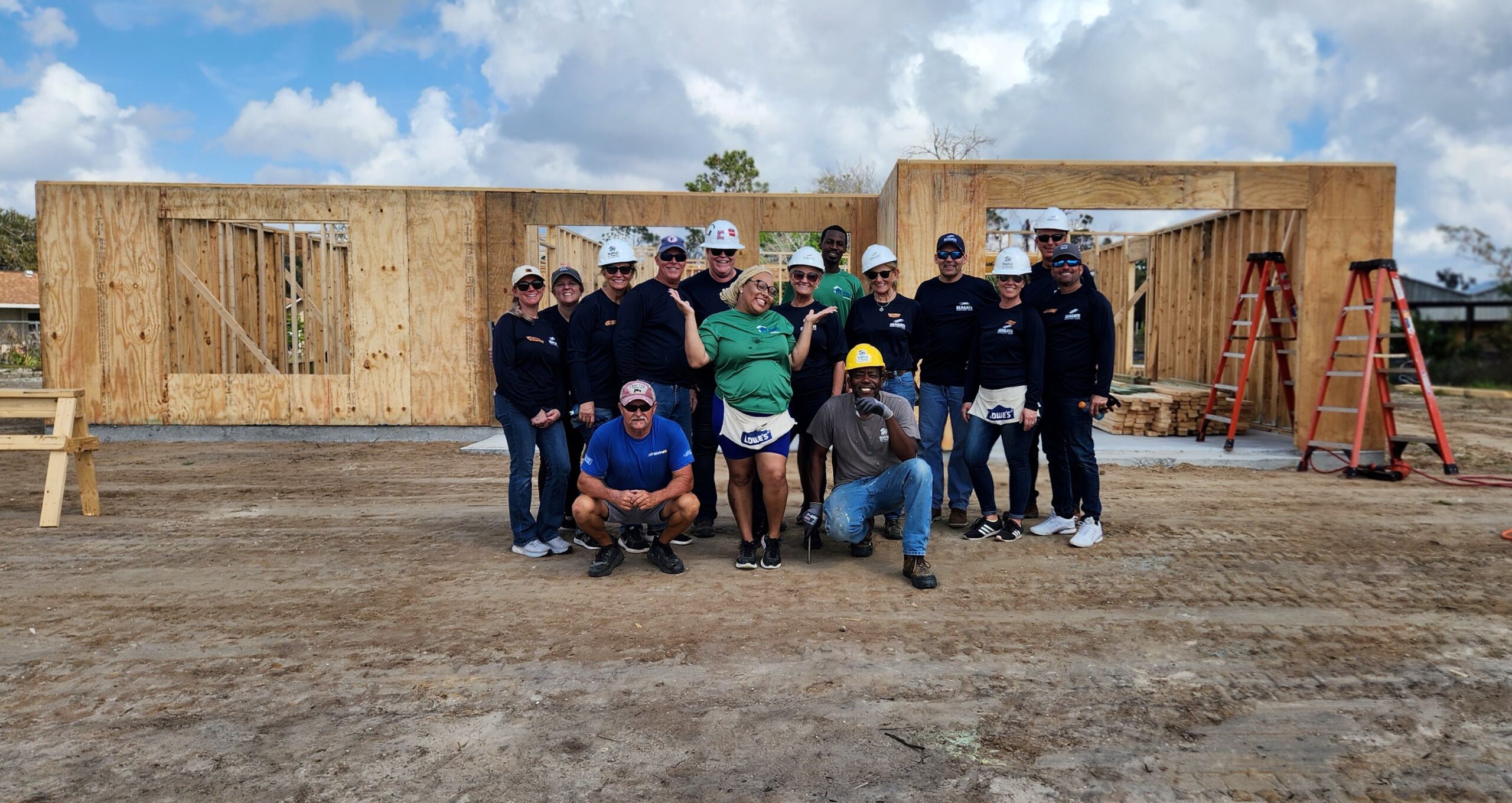 Seagate Development Group employees recently volunteered with Habitat for Humanity to help build a new home for Bree (middle green shirt).